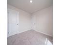A standard bedroom with neutral carpet, and two white doors with silver hardware at 4301 Summit Woods Dr, Charlotte, NC 28216