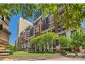 Beautiful condominium building showcasing brick facade, balconies, landscaping, and the vibrant city skyline at 435 S Tryon St, Charlotte, NC 28202