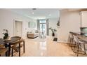 Bright living room with hardwood floors, a cozy sofa, elegant decor, and barstool seating by the kitchen at 435 S Tryon St, Charlotte, NC 28202