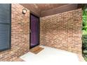 Covered front porch with brick siding, accent lighting, and a welcoming 'Welcome' mat at 4813 Carving Tree Dr, Mint Hill, NC 28227