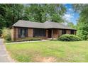 Traditional brick home with black shutters, tidy landscaping, and a spacious front lawn at 4813 Carving Tree Dr, Mint Hill, NC 28227