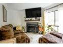Comfortable living room featuring a fireplace, TV, and neutral color scheme creating a cozy atmosphere at 4816 Spring Lake Dr # B, Charlotte, NC 28212