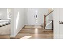 Bright, naturally lit foyer showcasing wood flooring and a staircase leading to the upper level at 5532 Muckross Ln, Fort Mill, SC 29707