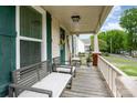 Inviting front porch featuring cozy benches and views of the neighborhood street at 557 Hunter Ave, Kannapolis, NC 28083