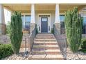 Inviting front entrance with brick steps, black iron railings, and lush landscaping on either side at 6352 Willow Farm Dr, Denver, NC 28037
