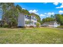 Beautiful two-story home featuring a well-maintained lawn and a serene, wooded backdrop at 7536 Bimini Ct, Sherrills Ford, NC 28673