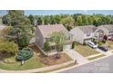 Aerial view of a two-story home showcasing mature landscaping and a desirable neighborhood at 7638 Carrington Forest Ln, Matthews, NC 28105