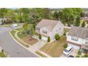 Aerial view of a two-story home showcasing manicured lawns and a peaceful neighborhood setting at 7638 Carrington Forest Ln, Matthews, NC 28105