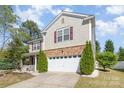 Charming two-story home with stone accents, attached garage, and well-manicured landscaping at 7638 Carrington Forest Ln, Matthews, NC 28105