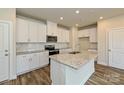 Modern kitchen featuring white cabinets, stainless steel appliances, and granite countertops at 812 Blue Canyon Dr, York, SC 29745