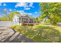 Attractive home with a covered front porch, colorful flowers, and a well-maintained lawn at 911 Earl St, Shelby, NC 28150