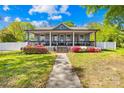 Charming home with a spacious front porch and lush landscaping, creating a welcoming curb appeal at 911 Earl St, Shelby, NC 28150