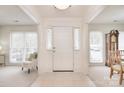 Bright foyer featuring neutral tile flooring and a glimpse into adjacent living spaces at 9208 Plashet Ln, Mint Hill, NC 28227
