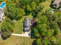 Aerial view showcases a home with a spacious backyard, including a possible garden, patio area and surrounding green trees at 127 Fantasy Ln, Mooresville, NC 28117