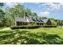 Charming home with a well-maintained lawn, classic brick accents, and inviting front porch perfect for relaxing evenings at 127 Fantasy Ln, Mooresville, NC 28117