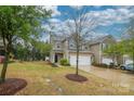 Charming two-story townhome with a well-manicured lawn and attached two-car garage at 1333 Rainier Dr, Fort Mill, SC 29708
