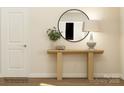 Bright entryway features a wood console table, round mirror and contemporary decor at 1541 Croydon St, Indian Land, SC 29707