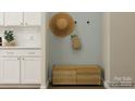 Entryway mudroom with storage bench, white cabinets, and stylish wall decor at 1541 Croydon St, Indian Land, SC 29707
