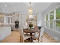 Charming breakfast nook featuring a round wooden table, four chairs, and a stylish chandelier at 1717 Brawley School Rd, Mooresville, NC 28117