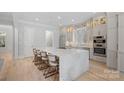 Spacious kitchen with a large island, stainless steel appliances, and custom cabinetry, perfect for cooking and gathering at 1717 Brawley School Rd, Mooresville, NC 28117
