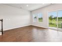 Living room featuring wood floors, large windows, and a glass sliding door at 1930 Old Rivers Rd, Concord, NC 28027