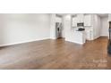 An open concept living room and kitchen featuring wood floors at 1930 Old Rivers Rd, Concord, NC 28027