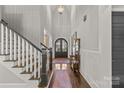Light-filled foyer with hardwood floors, staircase and elegant decor creates a welcoming atmosphere at 2137 Foxcroft Woods Ln, Charlotte, NC 28211