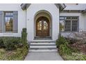 Elegant arched entryway with double doors, providing a grand welcome to the home at 2137 Foxcroft Woods Ln, Charlotte, NC 28211