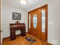 Inviting foyer with decorative wood door, sidelights, desk and hardwood floors at 2251 Old Applewood Ln # 9, Iron Station, NC 28080