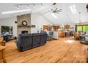 Bright and airy living room featuring a brick fireplace, skylights, and open floor plan at 2251 Old Applewood Ln # 9, Iron Station, NC 28080