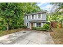 Charming two-story home with light-blue siding, white shutters, well-maintained landscaping, and a concrete driveway at 248 Pangle Dr, Charlotte, NC 28217