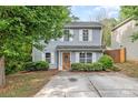 Charming two-story home with light-blue siding, white shutters, well-maintained landscaping, and a concrete driveway at 248 Pangle Dr, Charlotte, NC 28217