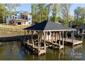 Waterfront home boasts a private dock with a charming gazebo, perfect for lakeside relaxation at 264 Fairway Shores Rd, Mount Gilead, NC 27306