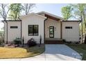 Inviting home exterior showcases a modern design with clean lines, beautiful landscaping, and a welcoming entrance at 264 Fairway Shores Rd, Mount Gilead, NC 27306