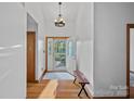 Inviting foyer with hardwood floors, decorative front door and bench seating, creating a warm welcome at 300 Yacht Rd, Mooresville, NC 28117