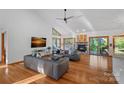 Bright living room features vaulted ceilings, a fireplace, hardwood floors, and modern furnishings at 300 Yacht Rd, Mooresville, NC 28117