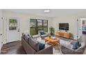 Bright living room features neutral colors, new hardwood floors, a large window, and stylish furnishings at 3108 Anne St, Charlotte, NC 28205