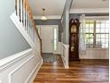 Elegant foyer with hardwood floors, staircase, grandfather clock, and a view of the front door at 3914 Cassidy Dr, Waxhaw, NC 28173