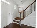 Foyer with hardwood floors, staircase with wrought iron details, and white paneled walls at 4040 Lauren Elizabeth Dr, Rock Hill, SC 29732