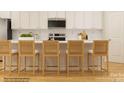 Contemporary kitchen boasts white cabinets, tiled backsplash, stainless steel appliances, and stylish bar stool seating at 4109 Camden Glen Rd, Lancaster, SC 29720