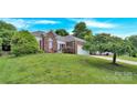Beautiful brick home with a well-manicured lawn and mature trees at 4155 Guilford Nw Ct, Concord, NC 28027
