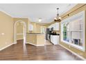 Inviting living room showcasing an eat-in kitchen, laminate flooring and natural light at 4155 Guilford Nw Ct, Concord, NC 28027