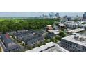 An aerial view of townhomes with a stunning skyline backdrop in a vibrant cityscape at 510 Music Hall Way, Charlotte, NC 28203