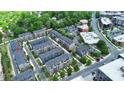 Aerial view showcases a neighborhood of townhomes, with tree-lined streets and beautiful landscaping at 510 Music Hall Way, Charlotte, NC 28203
