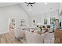 Sunlit living room with neutral decor, vaulted ceiling, and views of the landscaped backyard at 522 Waco Rd, Kings Mountain, NC 28086