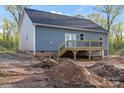View of the home's exterior featuring light blue siding and a wood deck at 524 Waco Rd, Kings Mountain, NC 28086
