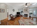 Living room with hardwood floors, fireplace, and a comfortable wicker chair at 5404 Dunedin Ln, Charlotte, NC 28270