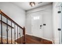 Inviting foyer with hardwood floors, staircase with decorative iron railing and a front door with window panes at 5628 Selkirkshire Rd, Charlotte, NC 28278