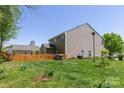 Expansive backyard featuring a well-maintained lawn and a classic wooden fence at 602 Black Maple Dr, Kannapolis, NC 28081