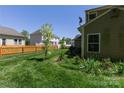 The property includes a well-kept lawn with a classic wooden fence and young trees at 602 Black Maple Dr, Kannapolis, NC 28081